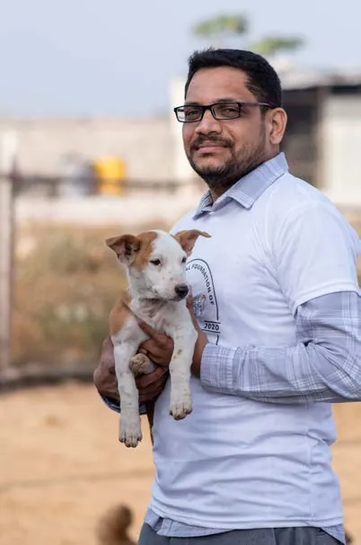 SAFI's cruelty prevention officer holding a rescued puppy