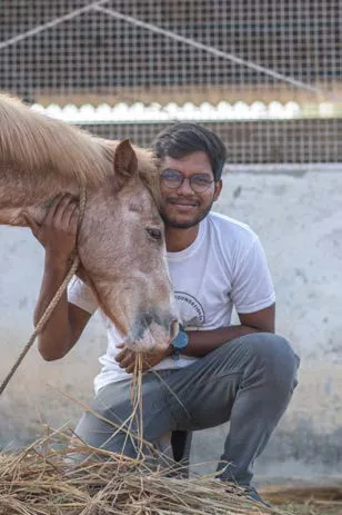 A SAFI staff member with a rescued cow